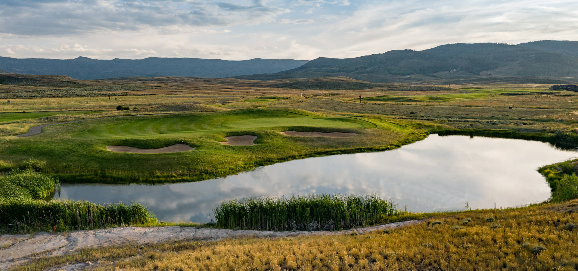 Image of golf ball on tee on grass.